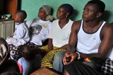 The Dosso family watch a TV broadcast of former Ivorian President Laurent Gbagbo appearing before the Hague's ICC