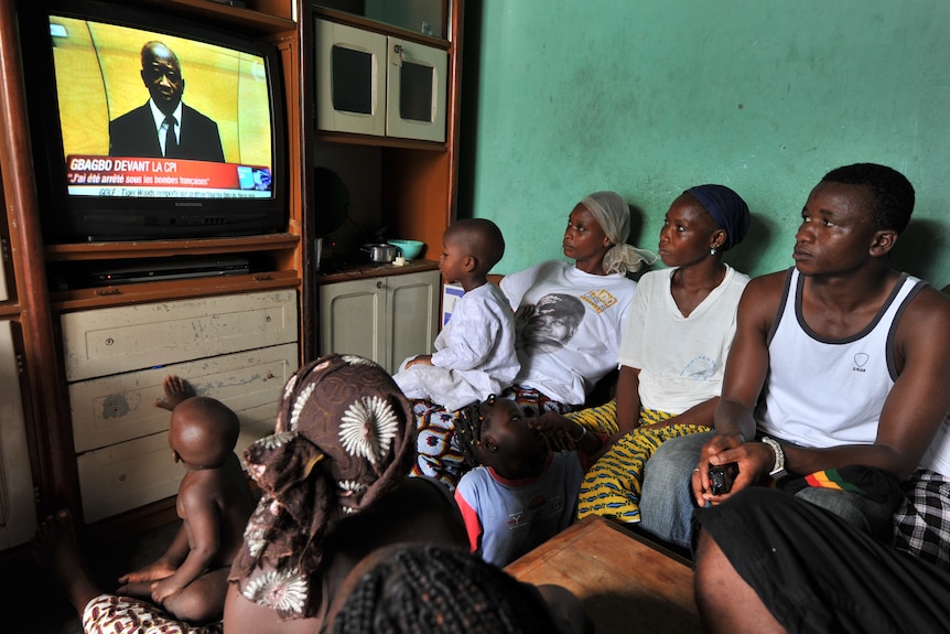 The Dosso family, who lost relatives in April's violence, watch the ICC broadcast.