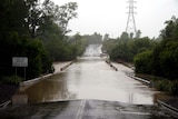 Floodwaters submerge the John Gay Bridge over the Nogoa River at Emerald. (File photo)