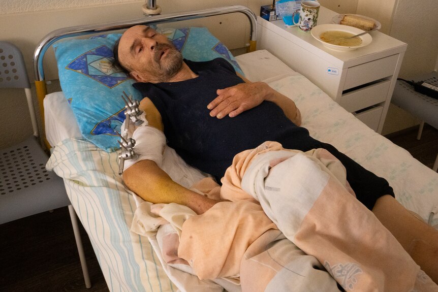 A badly injured man lies in hospital.