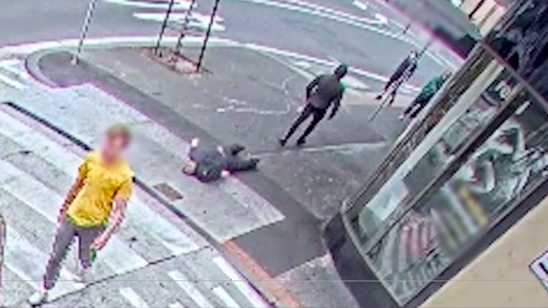CCTV footage of a man on the ground in broad daylight.