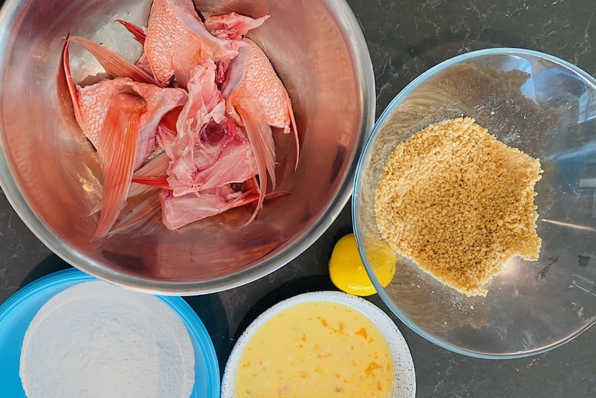 Photo of bowls filled with fish, crumbs and egg.