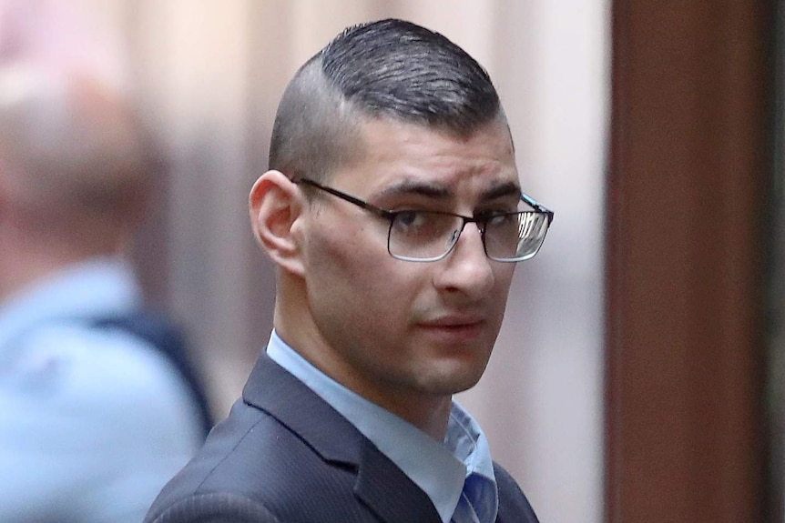 Joseph Esmaili is led from a prison van to court.