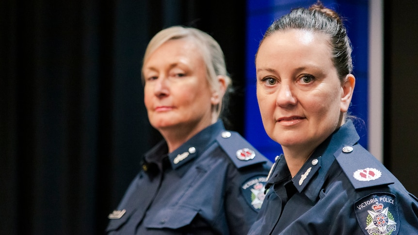 Two women in navy Victoria Police uniforms, standing side by side