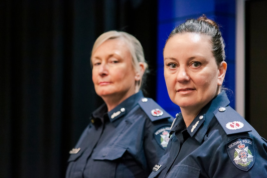 Two women in navy Victoria Police uniforms, standing side by side