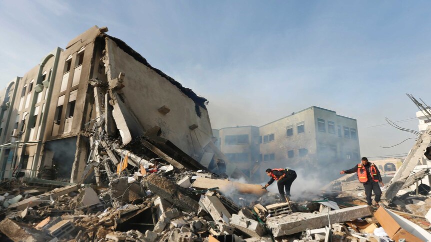 Firefighters try to extinguish a fire after an Israeli air strike on the building of Hamas' Ministry of Interior in Gaza City.