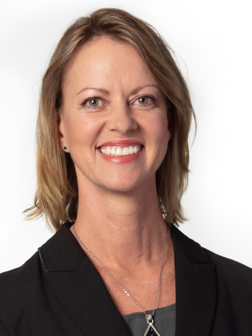 Lady smiling at camera, white backdrop