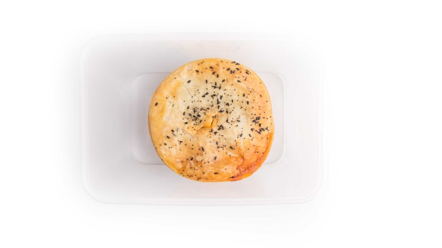 A chicken pie in a plastic container.