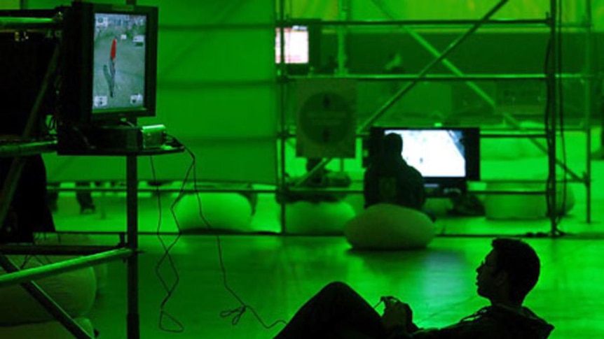 A gamer plays a video game at an Xbox 360 event.