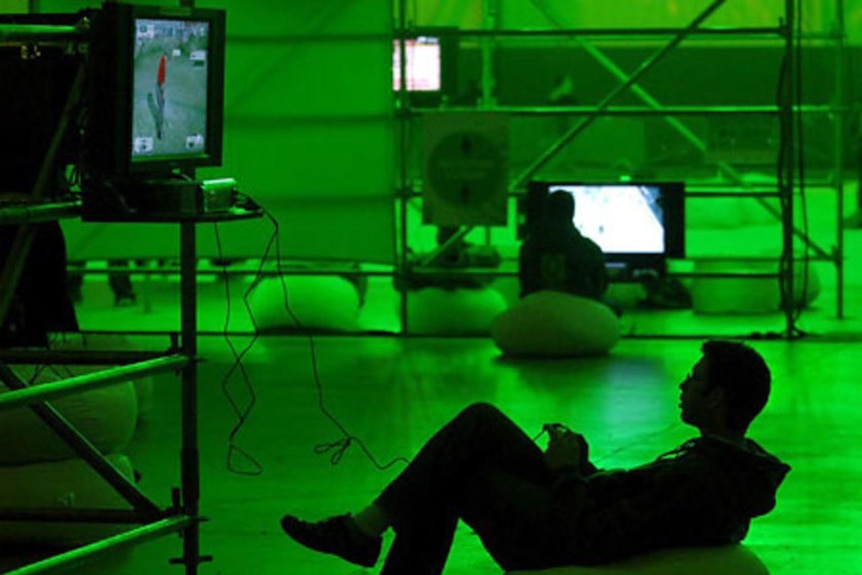 A gamer plays a video game at an Xbox 360 event.