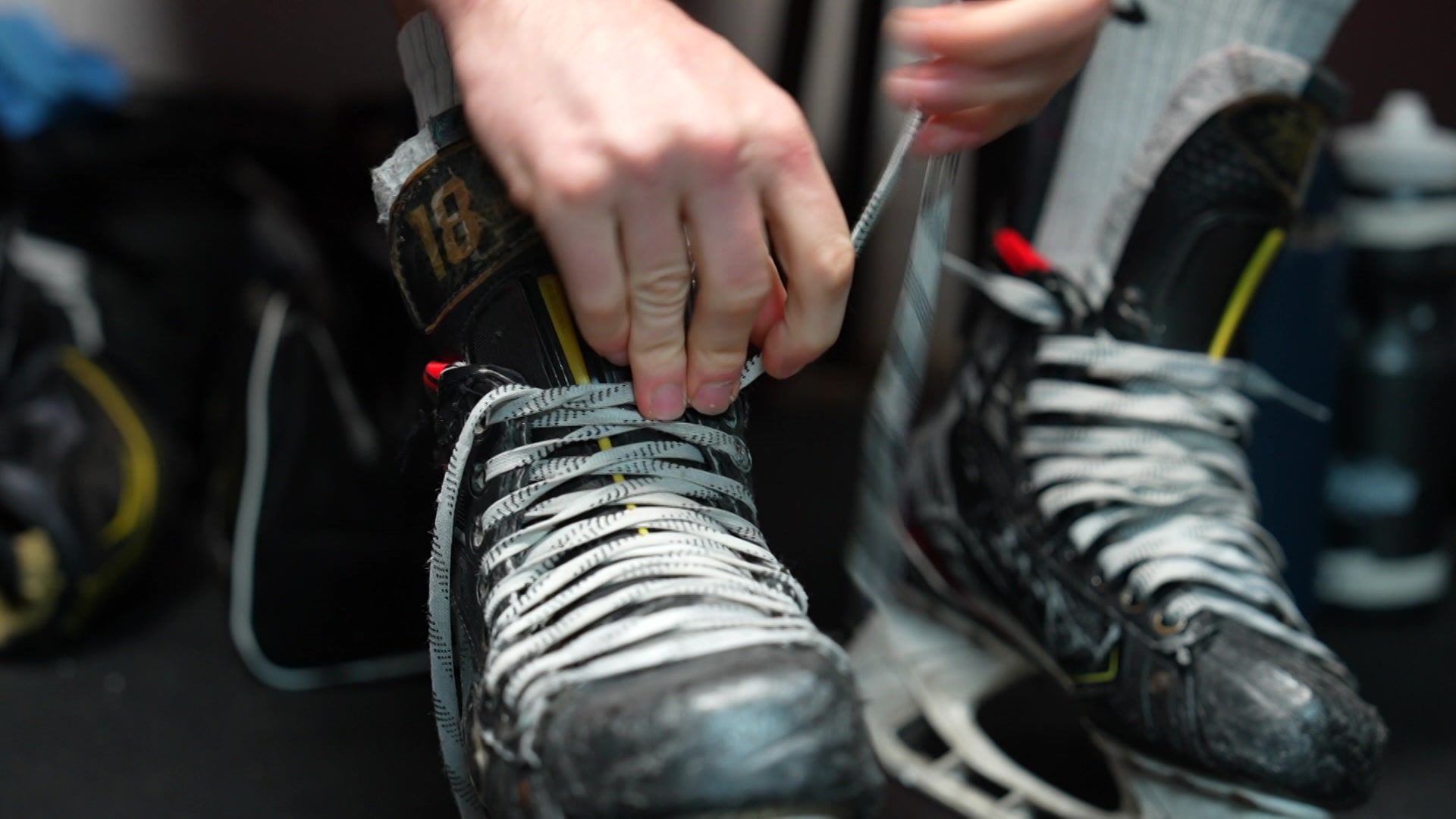 Ice hockey boots being tied up