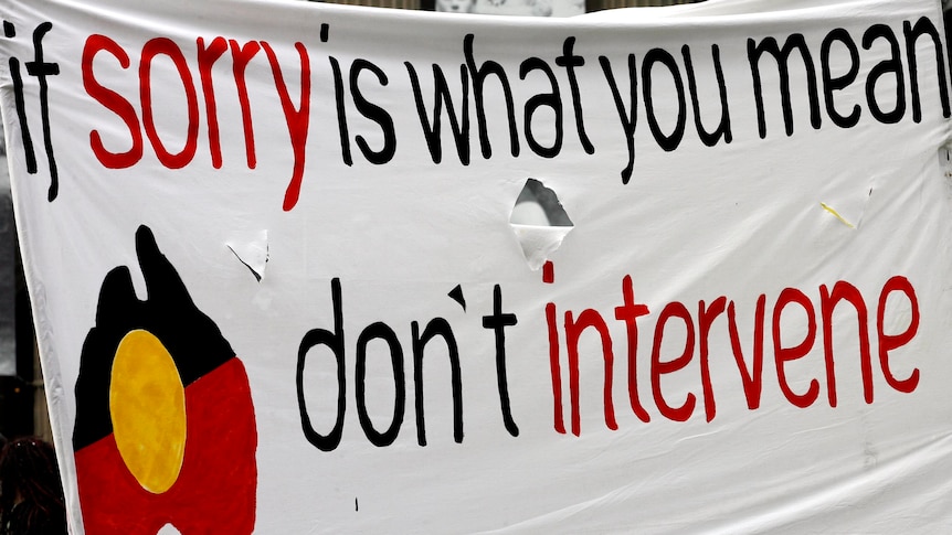 A banner at a rally calls for an end to the Northern Territory intervention. (AAP: Simon Mossman, file photo)