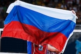 Russian athlete holds up the flag at London Olympics