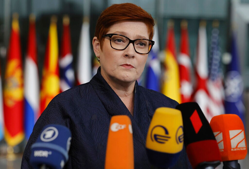 Marise Payne speaks in front of microphones.