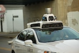 A car with cameras on its roof.