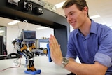 Engineering student Mattison Rose gives his robot a high five.