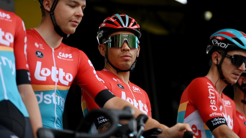 A cyclist looks at the camera before a race