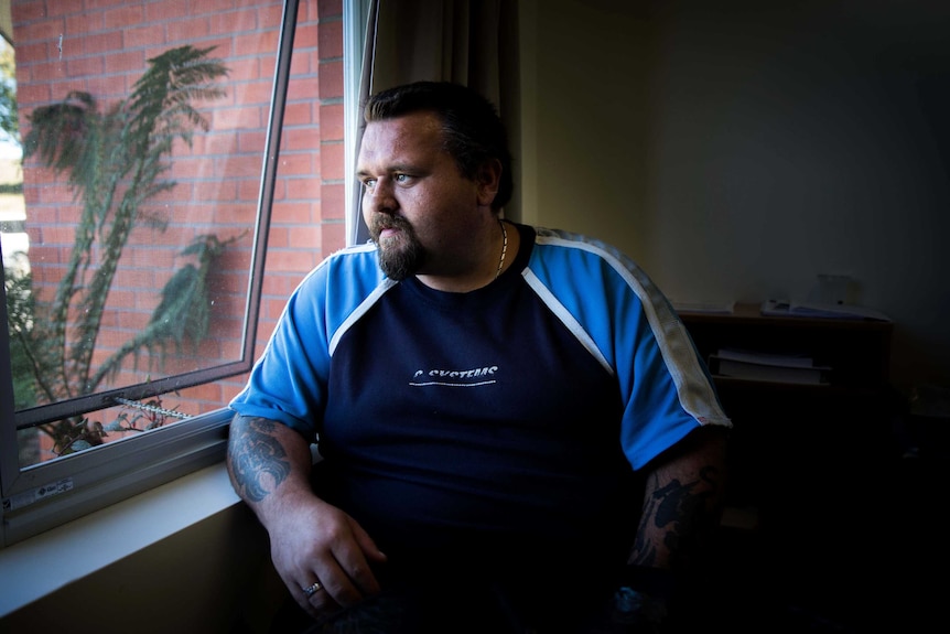 Former drug user Mark stares out a window.