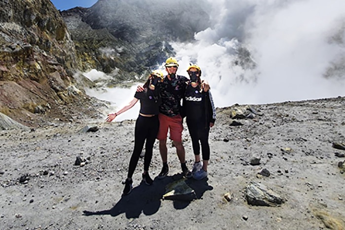 Browitt family stand on the crater rim of White Island Volcano before it exploded