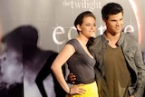 LtoR Kristen Stewart and Taylor Lautner pose for photos