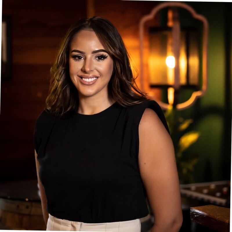 A headshot of a woman smiling