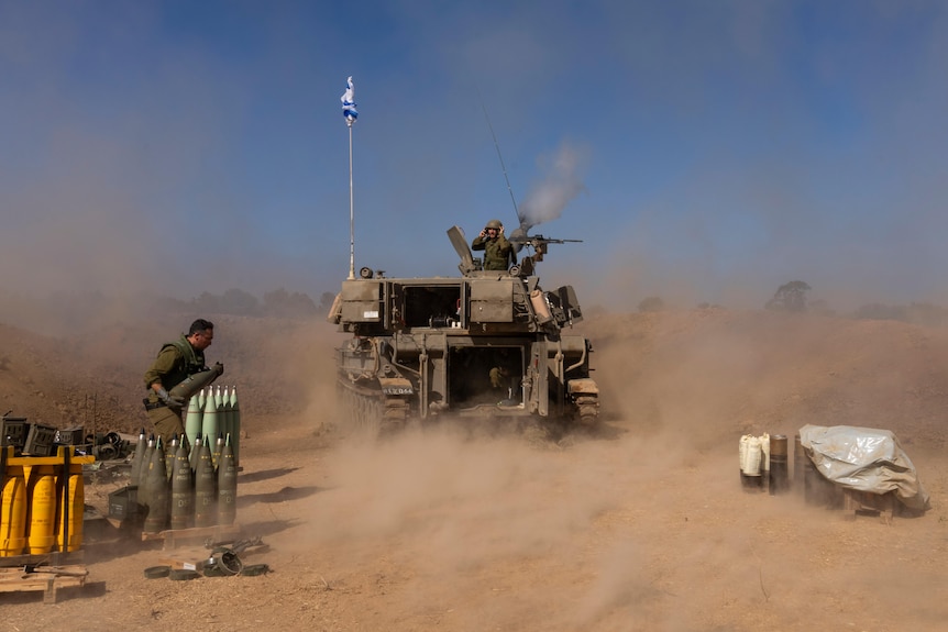 An Israeli mobile artillery unit fires a shell from southern Israel towards the Gaza Strip.