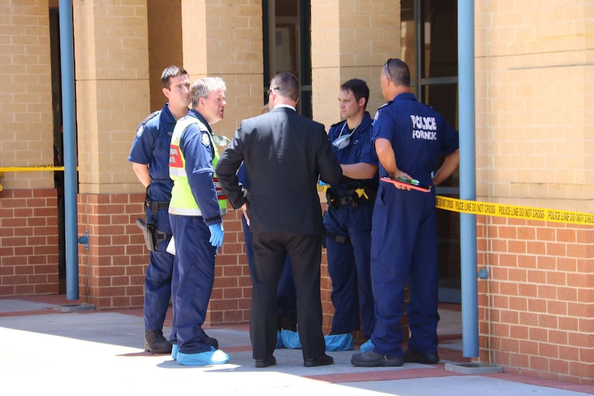Police and forensics officers outside Joondalup Courthouse with yellow police tape nearby.