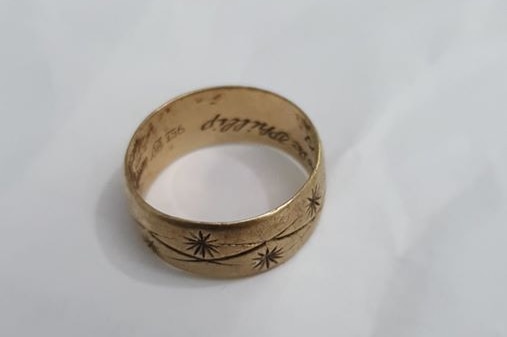 A gold ring with an inscription.
