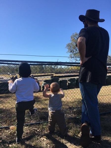 A man in a with two small children.