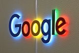 Google's logo is seen lit up on a wall inside the company's Sydney office.