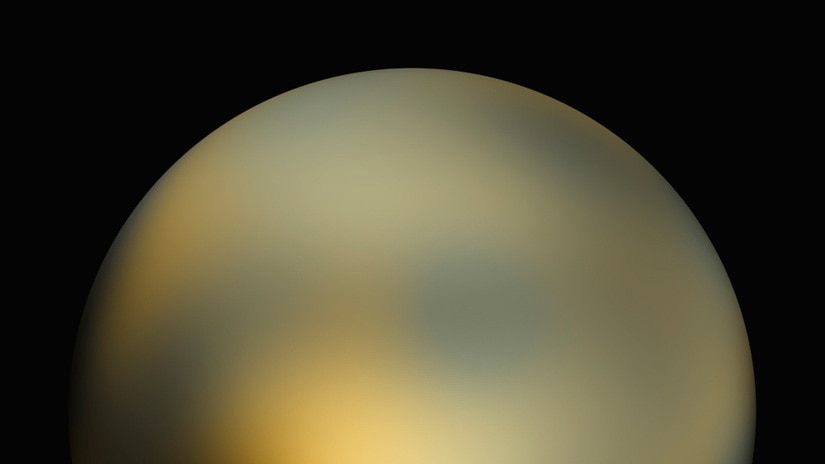This image of Pluto  by the Hubble Space Telescope shows it as a yellow ball with no clear features against a black background.