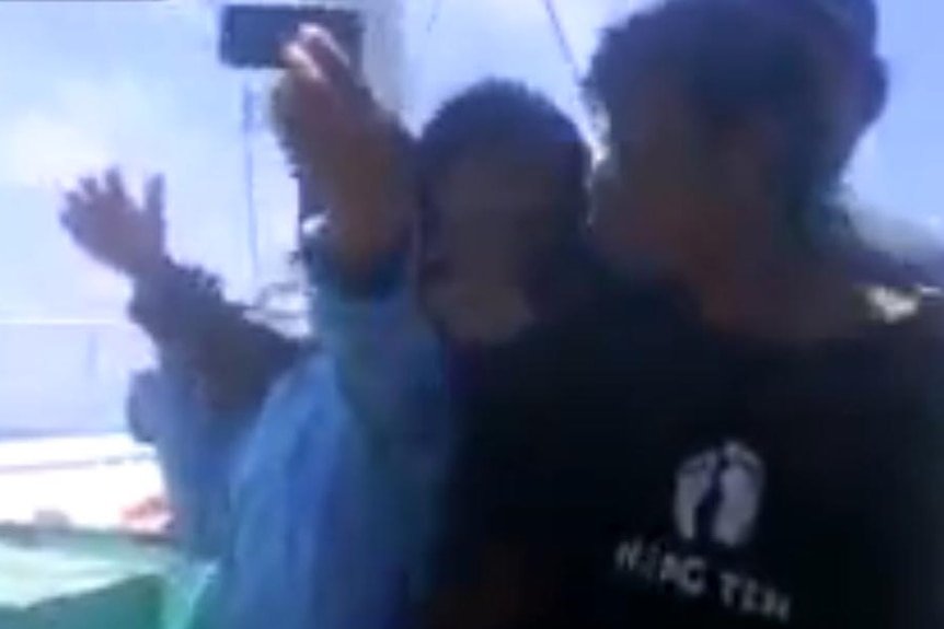 Men taking selfies after shooting dead men in ocean, uploaded Aug 19 2014