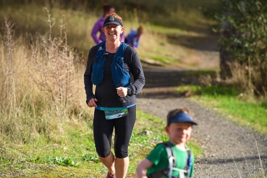 Kate Corner runs with a backpack on during parkrun.