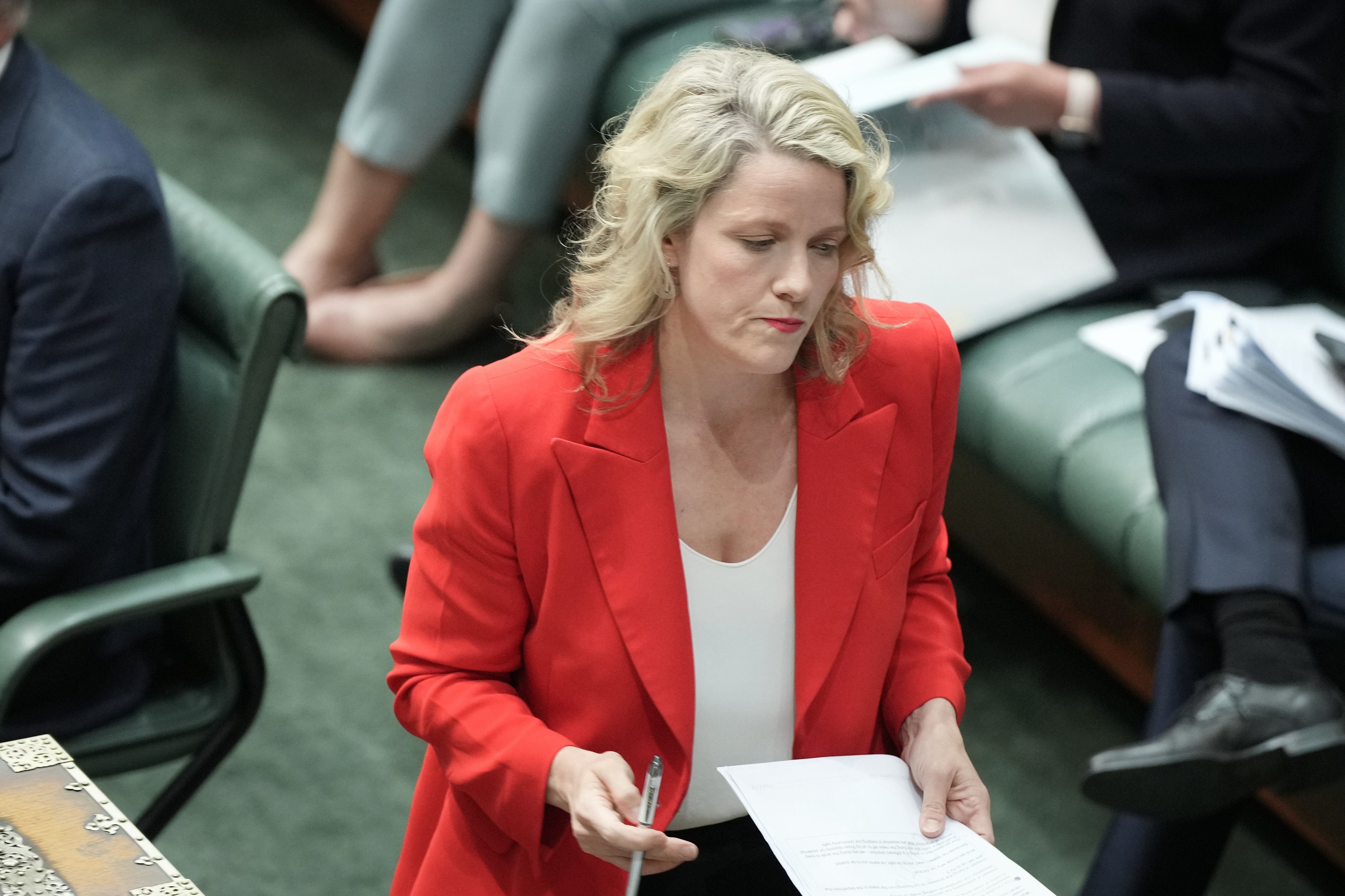 Clare O'Neil looks down as she walks from the despatch box in the House of Representative