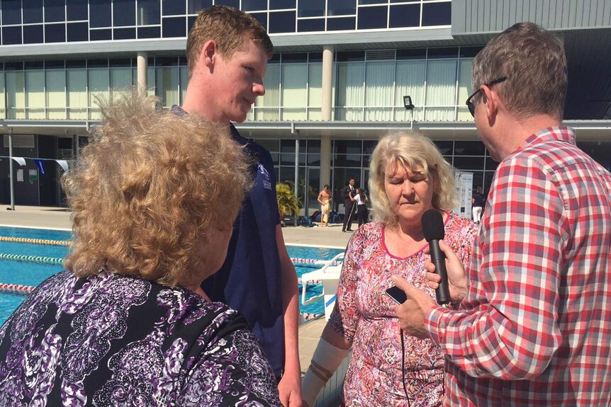 Liam Schluter, his grandmother Del Verrall (L) and mother Michelle Schluter speak to a reporter