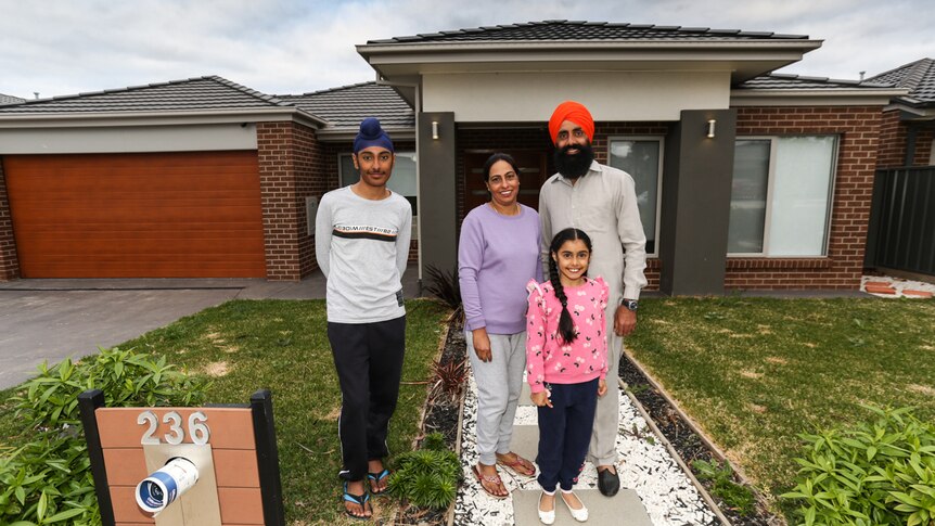The Sandhu family out front their brick Bendigo home.