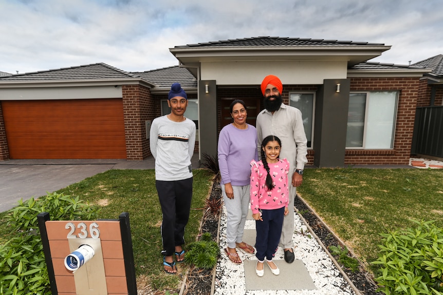 The Sandhu family out front their brick Bendigo home.