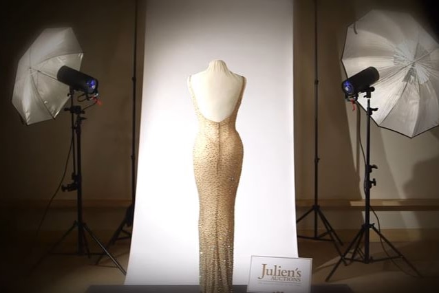 The back of the sequined dress on display against a white backdrop