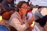 A woman attends a candle light vigil for domestic violence on the Gold Coast
