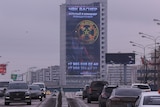 Giant screen has russian words on side of building