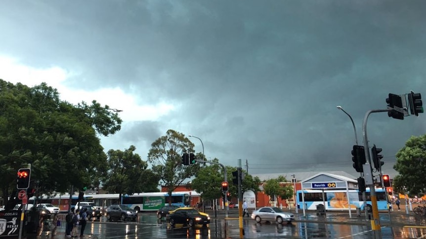 Storm clouds linger over a traffic intersection in Penrith