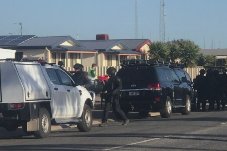 SA Police officers next to their vehicles.