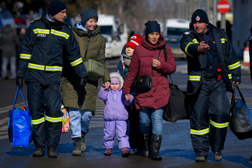 Romanian firefighters help refugees fleeing the conflict from neighbouring Ukraine after crossing the border.