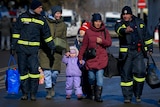 Romanian firefighters help refugees fleeing the conflict from neighbouring Ukraine after crossing the border.
