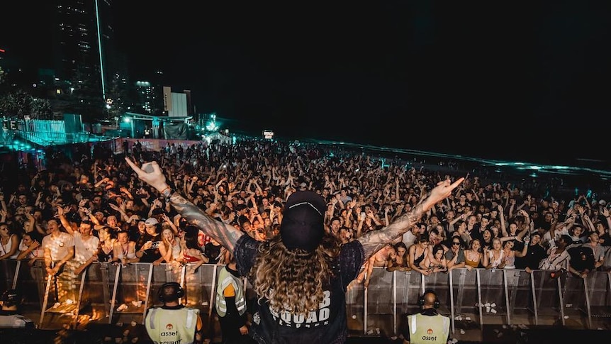 A large mosh pit at a Schoolies event in 2018 at Surfers Paradise beach.