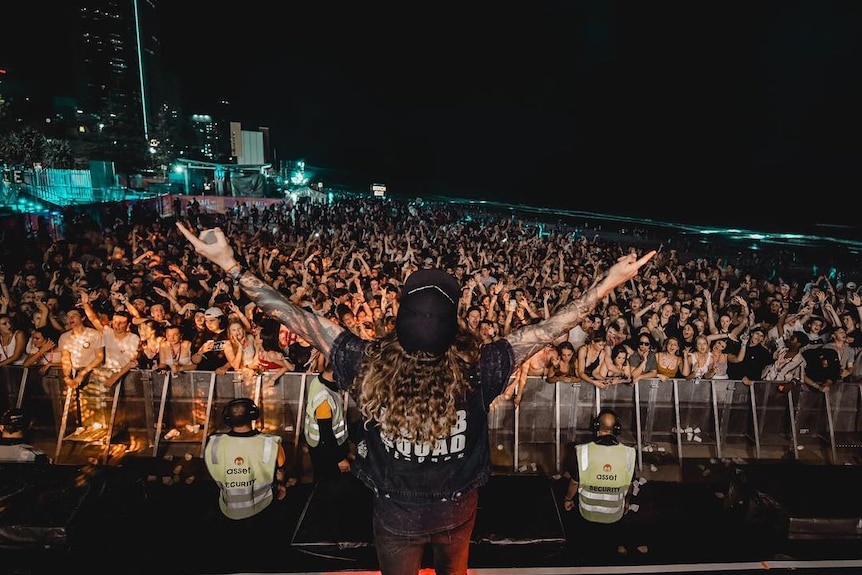 A large mosh pit at a Schoolies event in 2018 at Surfers Paradise beach.