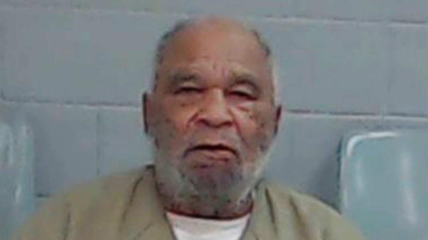 An older man wearing a prison uniform.