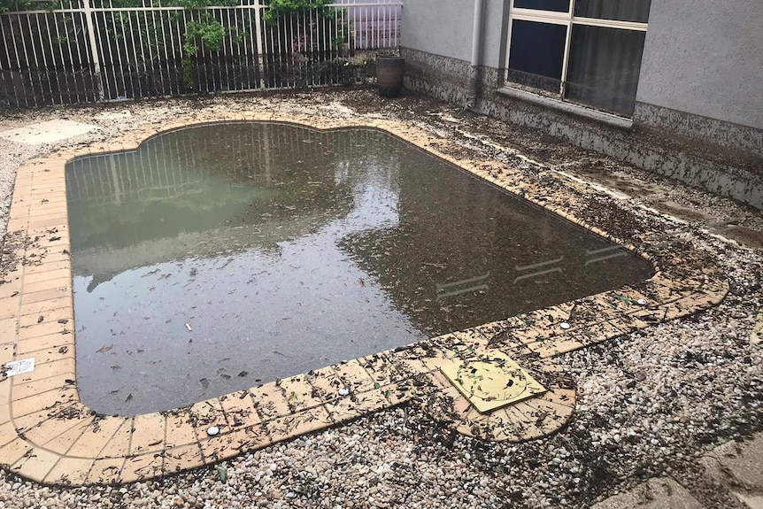 Muddy pool at a house in Townsville after floods.