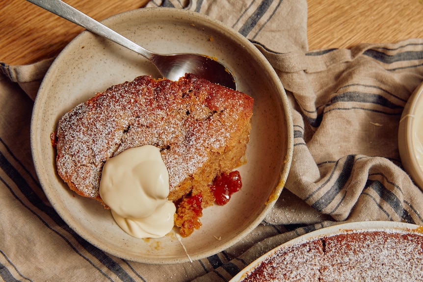 Picture of marmalade pudding in bowl with a dollop of cream