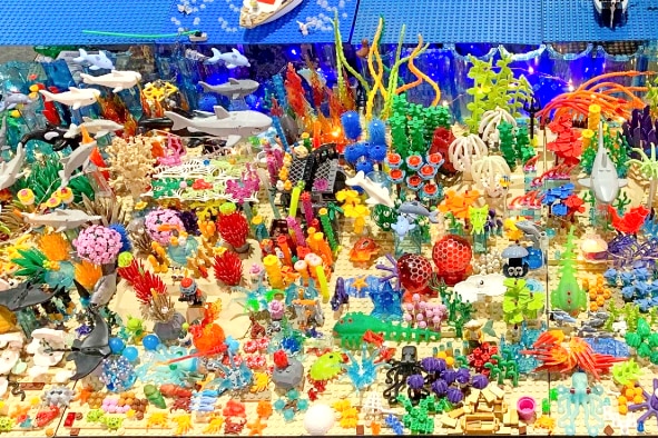 Intricate Lego model of Great Barrier Reef full of colourful sea creatures.